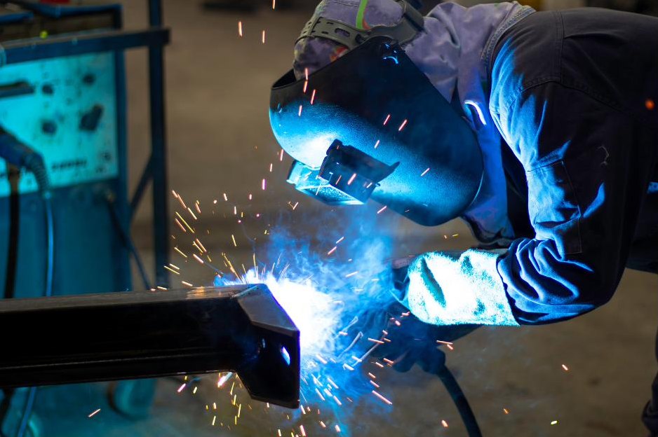 Angle grinder dressing a steel plate edge