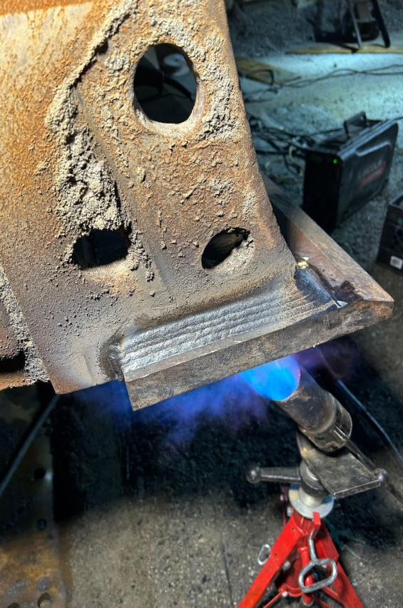 Torch preheating a cutting edge before the final weld pass